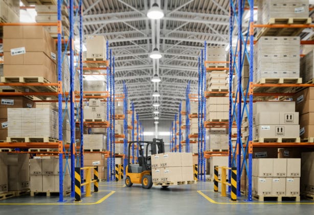 Forklift truck in warehouse or storage and shelves with cardboard