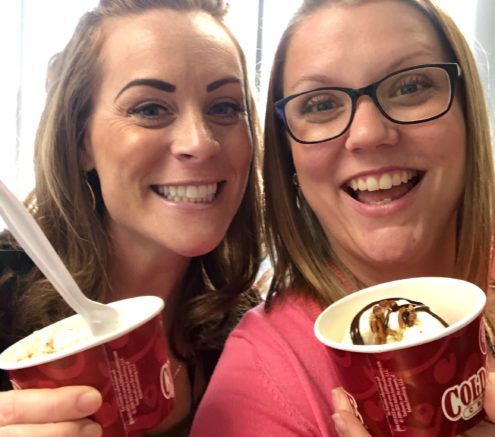 Two UniGroup employees take a photo with their ice cream sundaes.