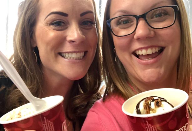 Two UniGroup employees take a photo with their ice cream sundaes.
