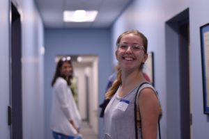 A student smiles while walking down the hallway