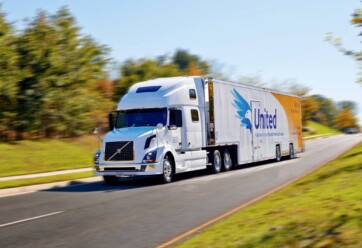 A Hilldrup truck driving down the road