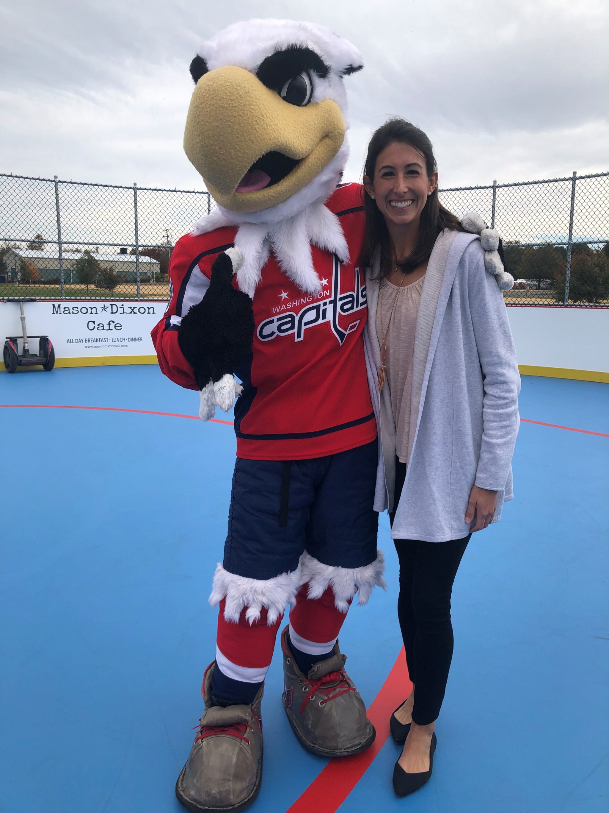 Slapshot, the Washington Capital's mascot, gives high five to kids at Dixon Park