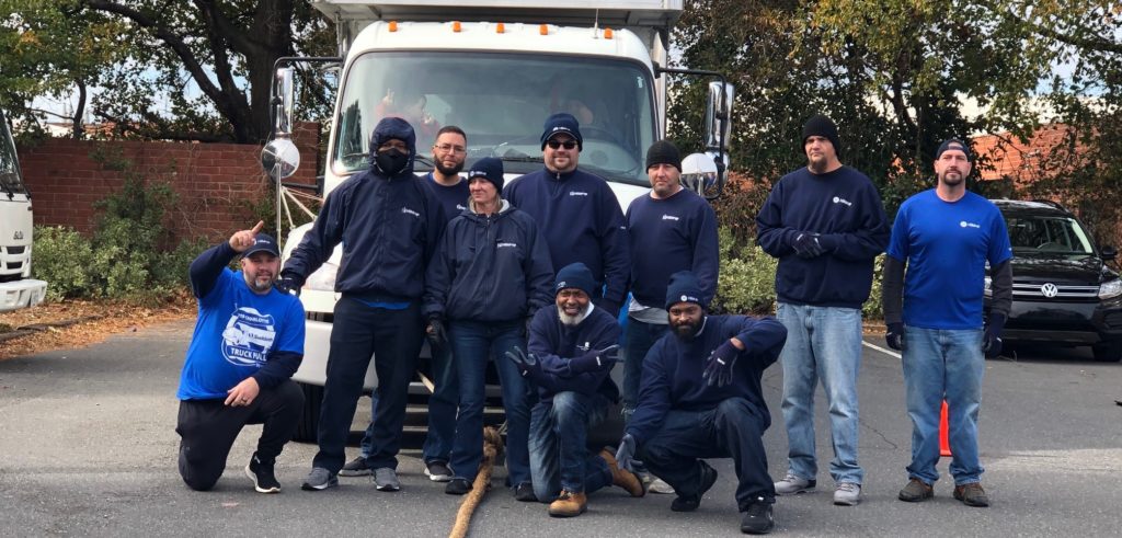 Hilldrup team gathers together before the start of the truck pull event