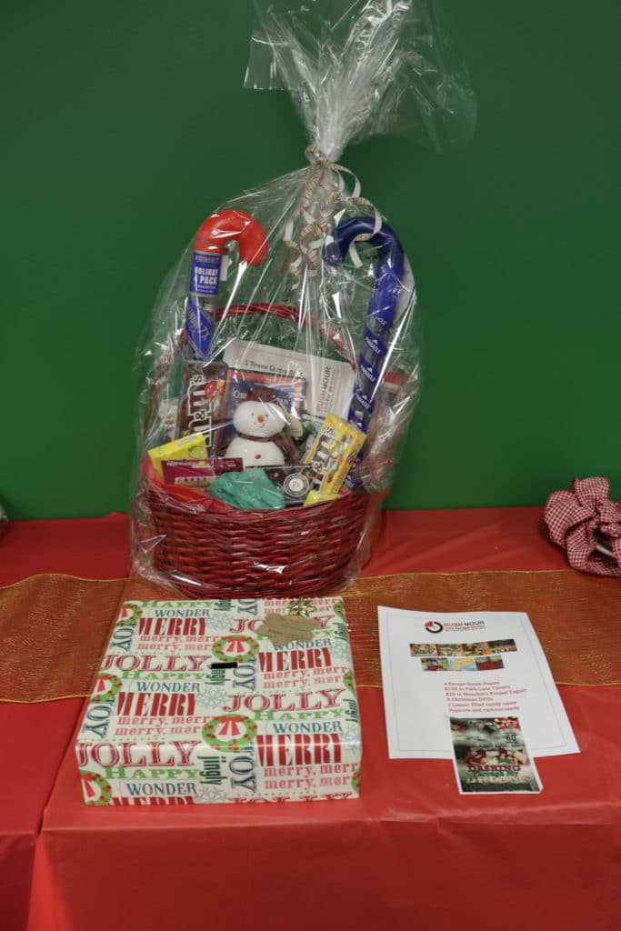 Christmas basket with gift cards and lottery tickets on table 