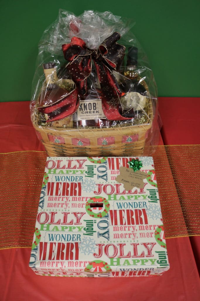 Basket with whiskey bottles and decorated for Christmas