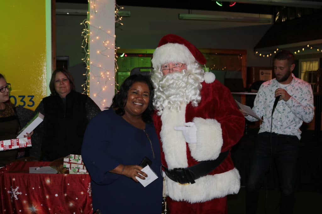 Joyce Callahan takes a photo with Santa during the Christmas party after winning a prize! 