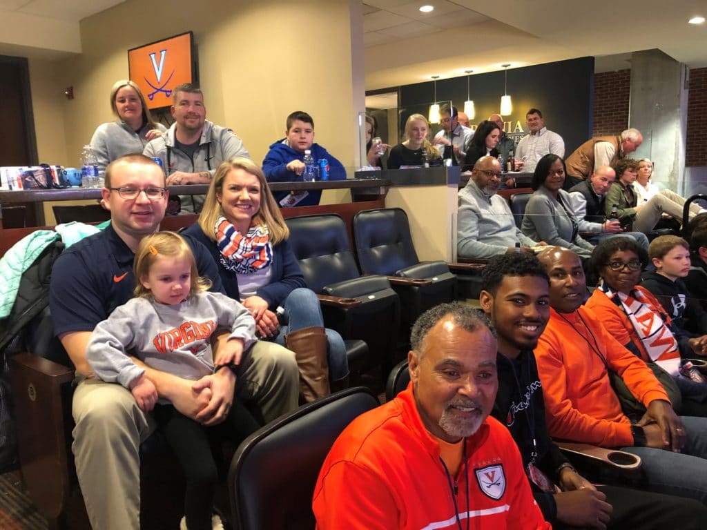 Team Hilldrup sits at the UVA game with our families. 