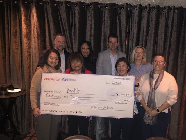 Members of Bechtel share a photo with the "big check" that Hilldrup provided to show our support for their philanthropy 