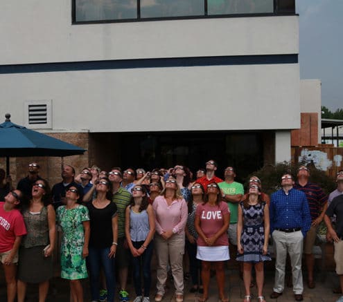 Hilldrup employees watching the solar eclipse in August 2017 with their solar eclipse glasses to protect their eyes