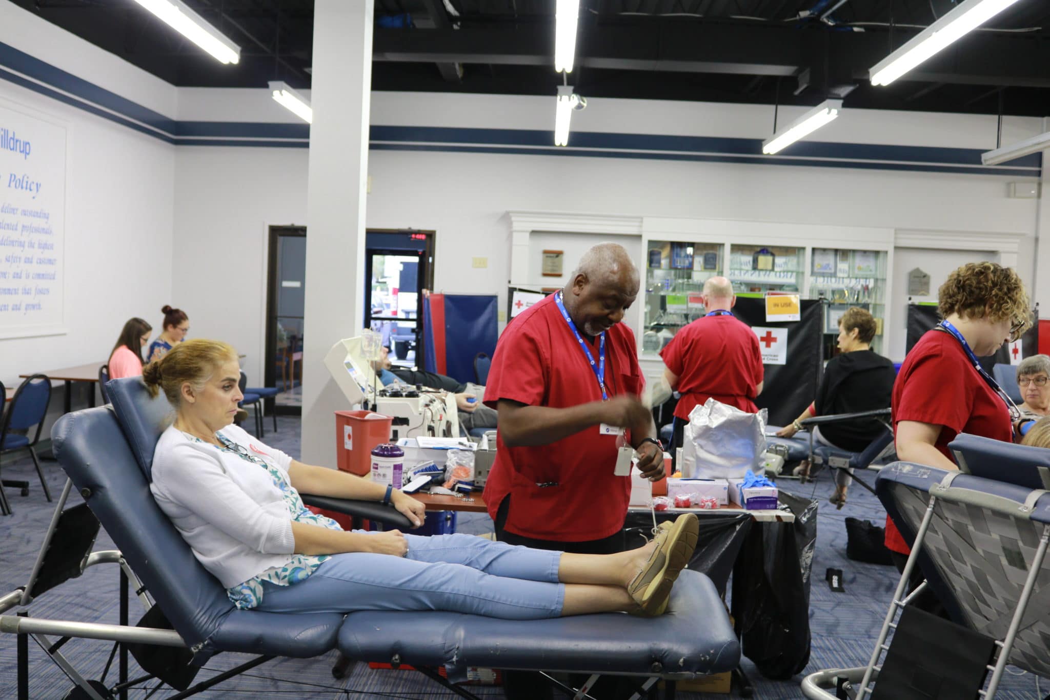Woman laying down giving blood during blood donation drive at Hilldrup office