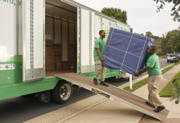 Two guys moving furniture onto a truck