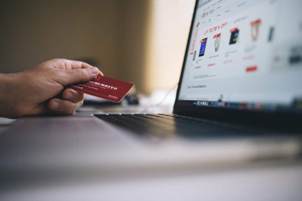 Person sitting at computer about to buy something with their credit card