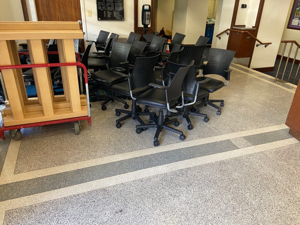 Student chairs are gathered in Thurston Hall to be stored. 