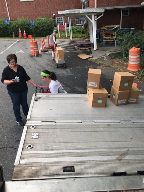 Volunteers helping with the food delivery with Move For Hunger