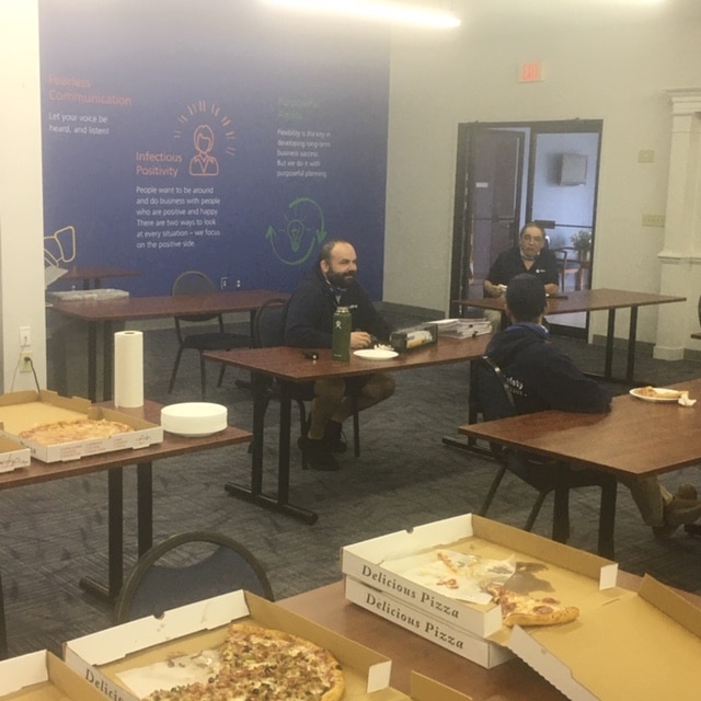 William Johnson enjoys a pizza party with colleagues at Hilldrup's Stafford office as part of his goodbye party. 