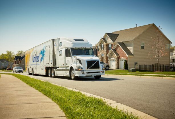 Hilldrup truck driving through a neighborhood.