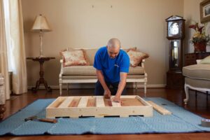 Hilldrup service team member crates a household goods item for a move.