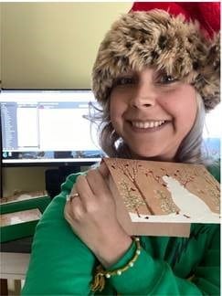 Hilldrup employee Darcy Duxbury takes a selfie with a Christmas card for a virtual game. 