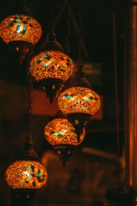 intricate colorful glass lights hanging in a dark room
