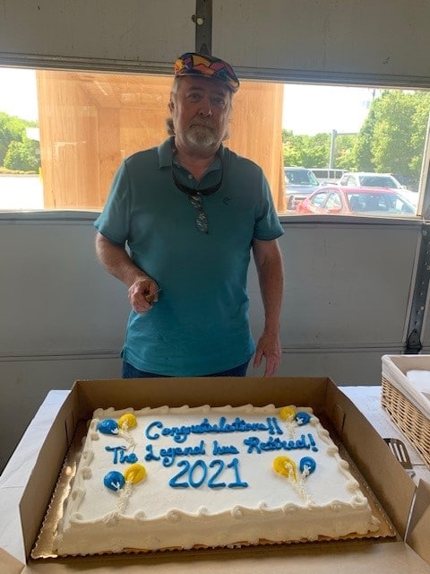 Ron Lewis enjoying his retirement cake at his retirement party. 