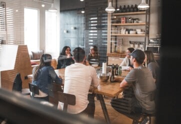 Young workers having a meeting in an open office space.