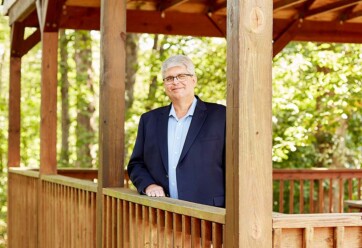 Rob Williams posing on wooden patio