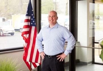 Jimmy Murray standing in front of American flag