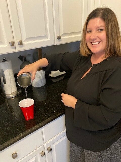 Carrie pouring a drink of water