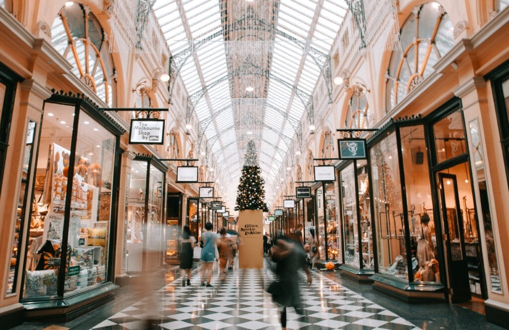 Mall decorated for Christmas with people shopping.