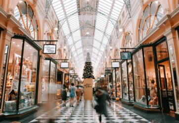 Mall decorated for Christmas with people shopping.