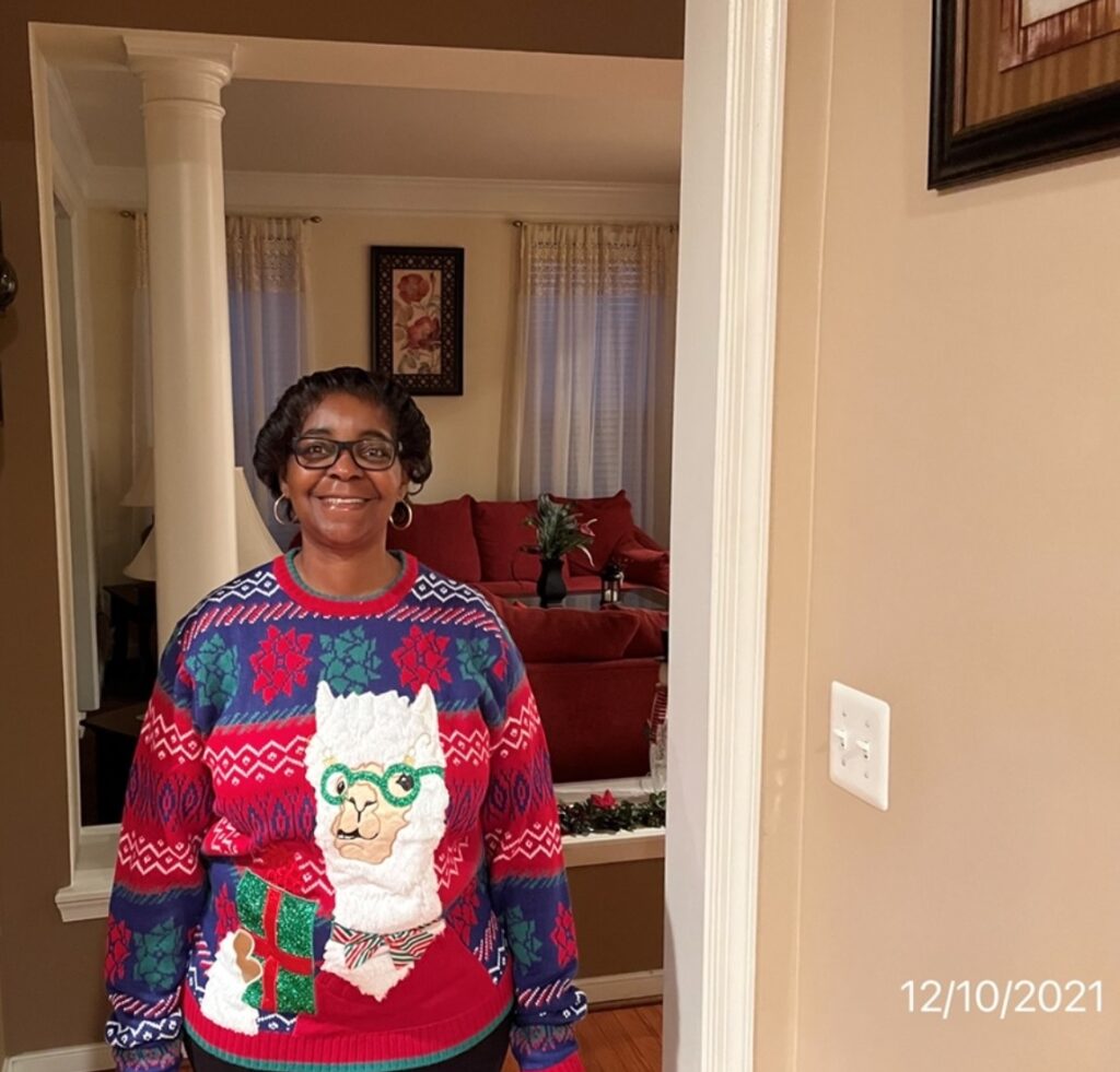 Leslie Tanner in a Christmas sweater 