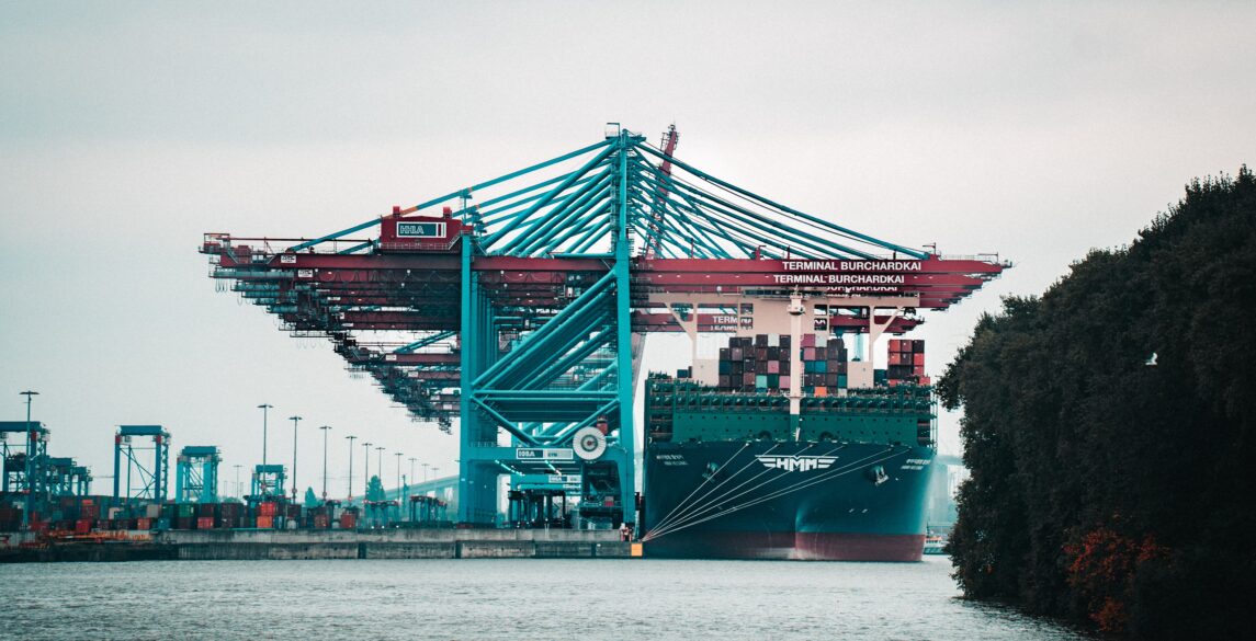 Far-away picture of a port and container ship.