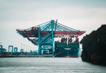 Far-away picture of a port and container ship.