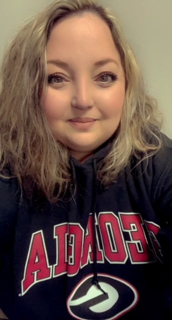 headshot of woman in football sweatshirt