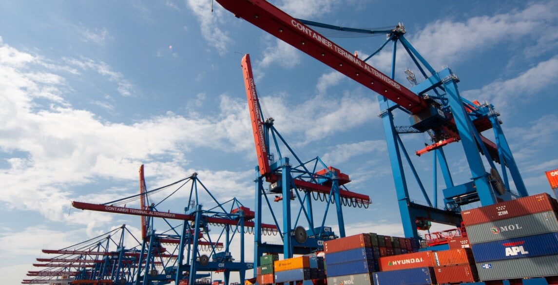 Shipping containers and cranes in a port.