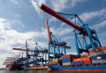 Shipping containers and cranes in a port.