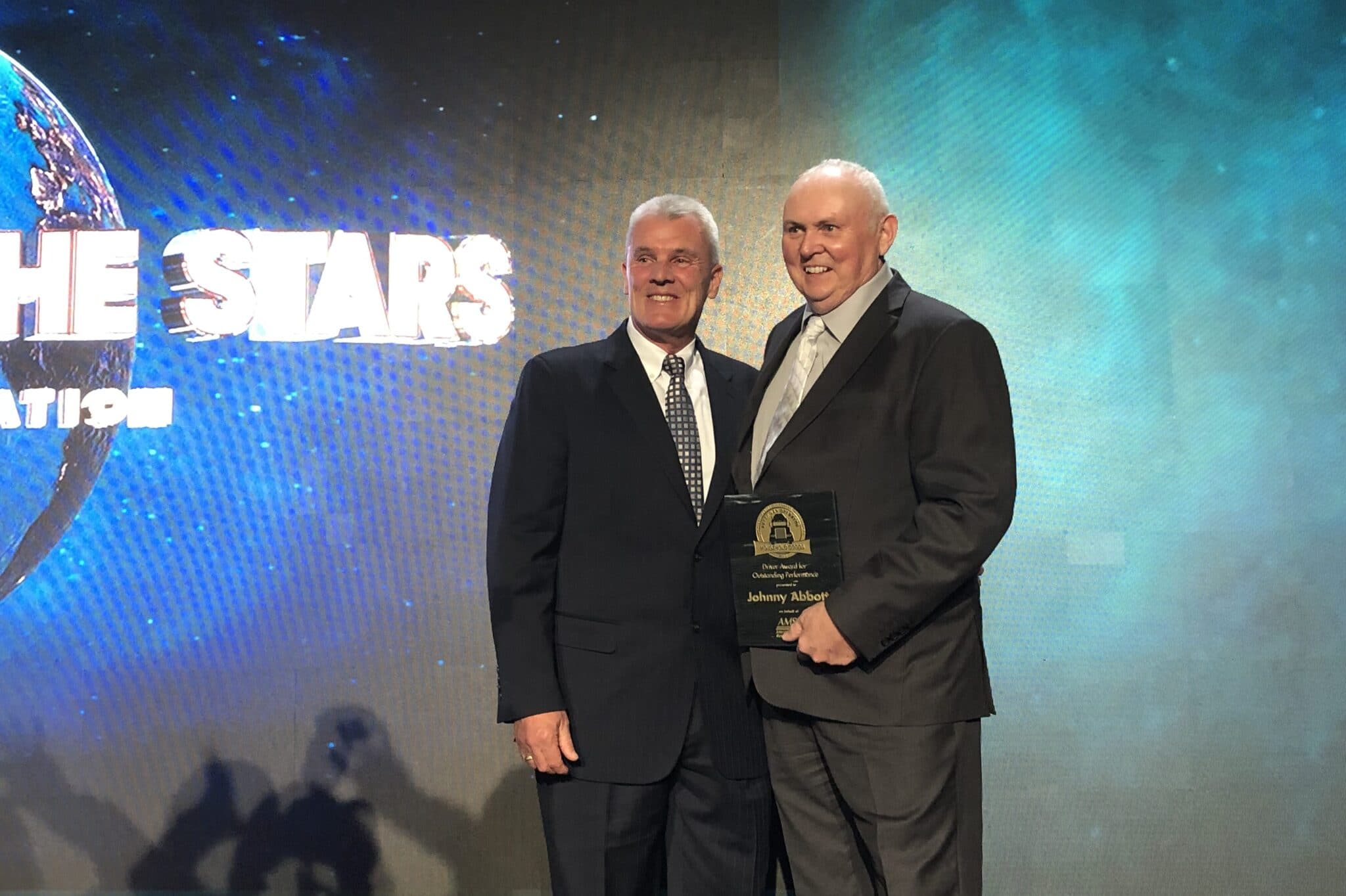 Johnny Abbott and Randy Rantz posing for a photo with award