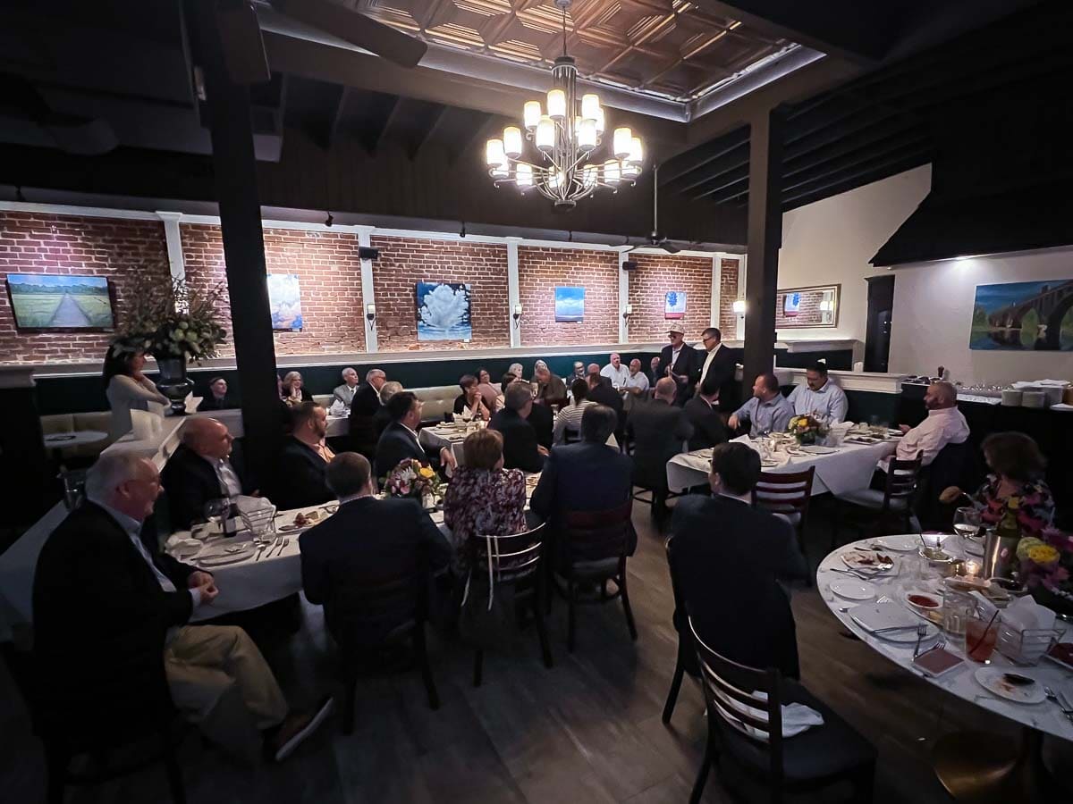 Zoomed out image of tables at a business dinner