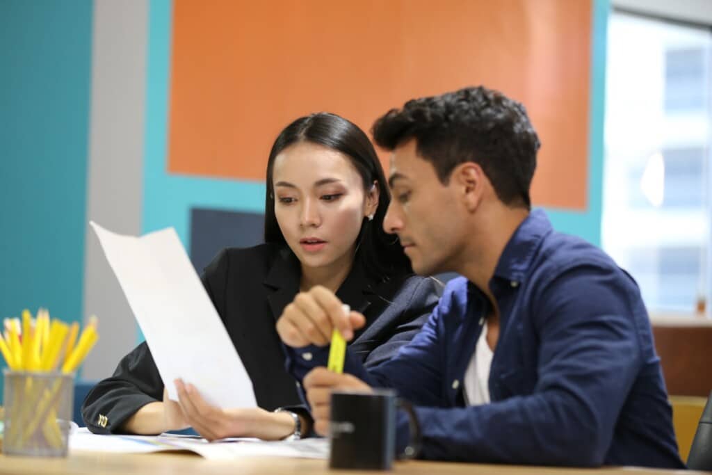 Employees reviewing paperwork.