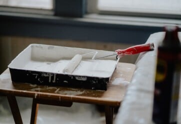 Picture of a paint roller with white paint.