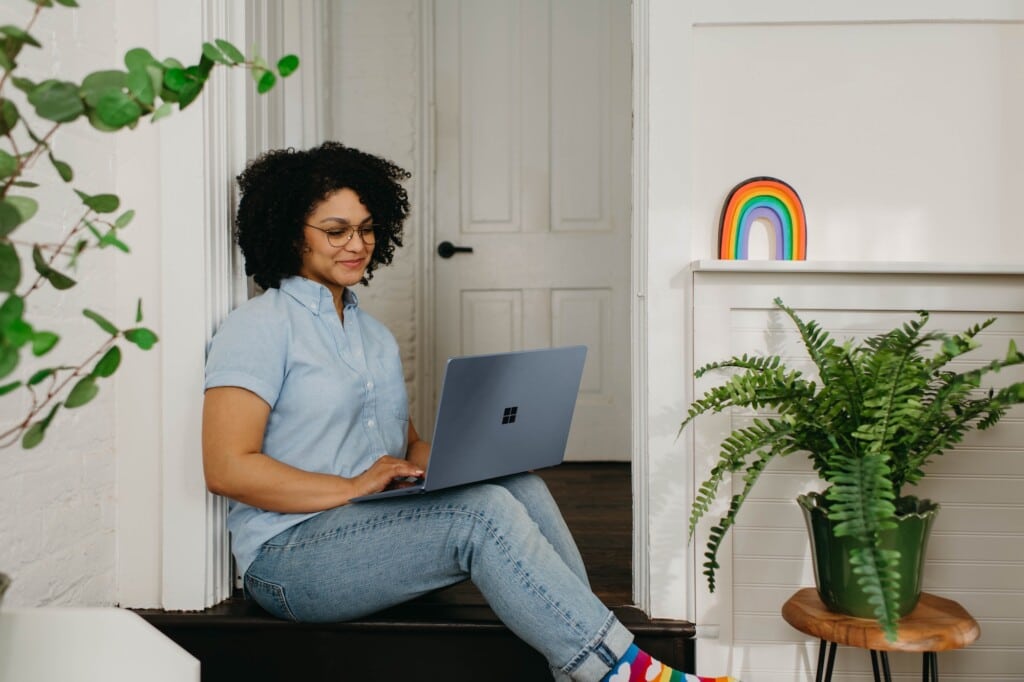 African-American woman working on a laptop at home.