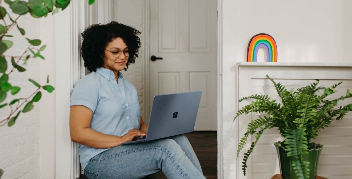 African-American woman working on a laptop at home.