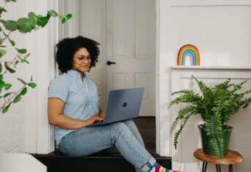 African-American woman working on a laptop at home.