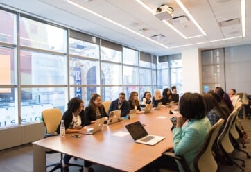 Group of professionals of different ethnicities sitting at a conference table