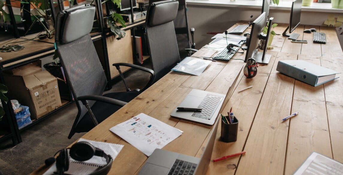 Long office with with multiple laptops