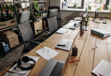 Long office with with multiple laptops