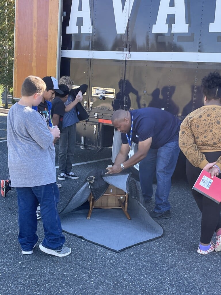 Caesar Lovett demonstrating packing during Career Day