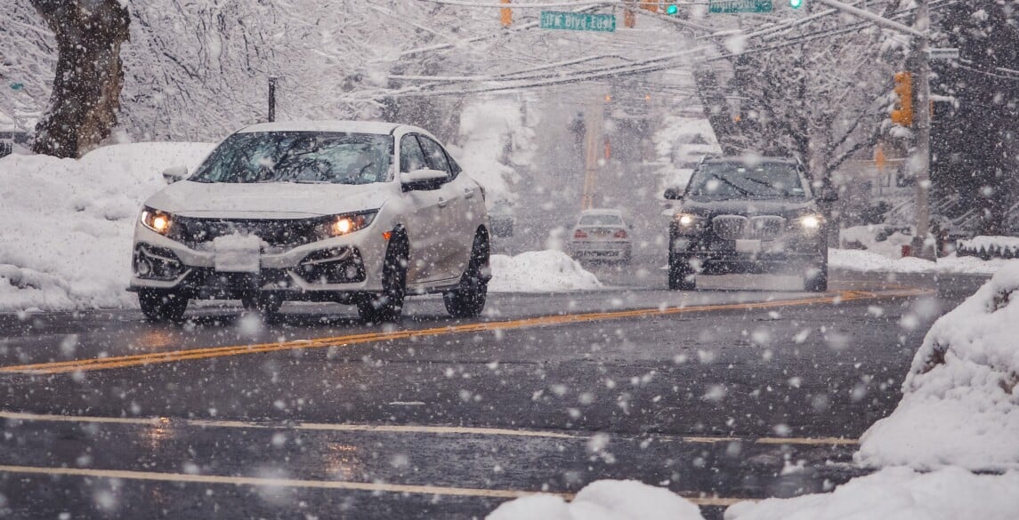Cars driving on a snowy street
