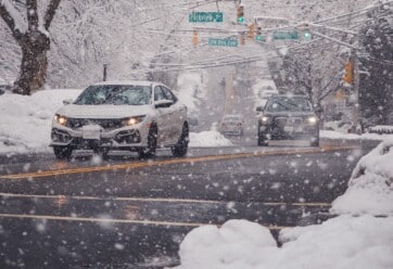 Cars driving on a snowy street