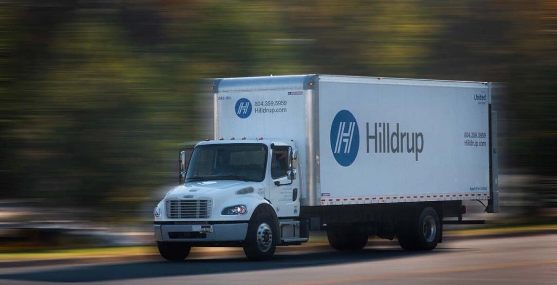 Hilldrup truck driving on road.